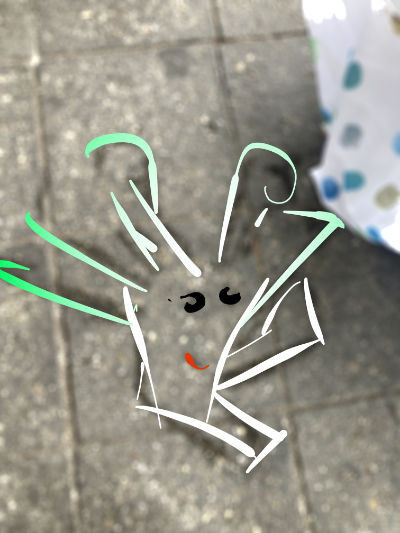 Overlaid some paint strokes onto the photo from before. The character looks like it's a face with legs doing a dynamic jumping or sliding motion. It resembles a white turnip or leek, its hair turning from white to green the further away it is from the small dude's face.